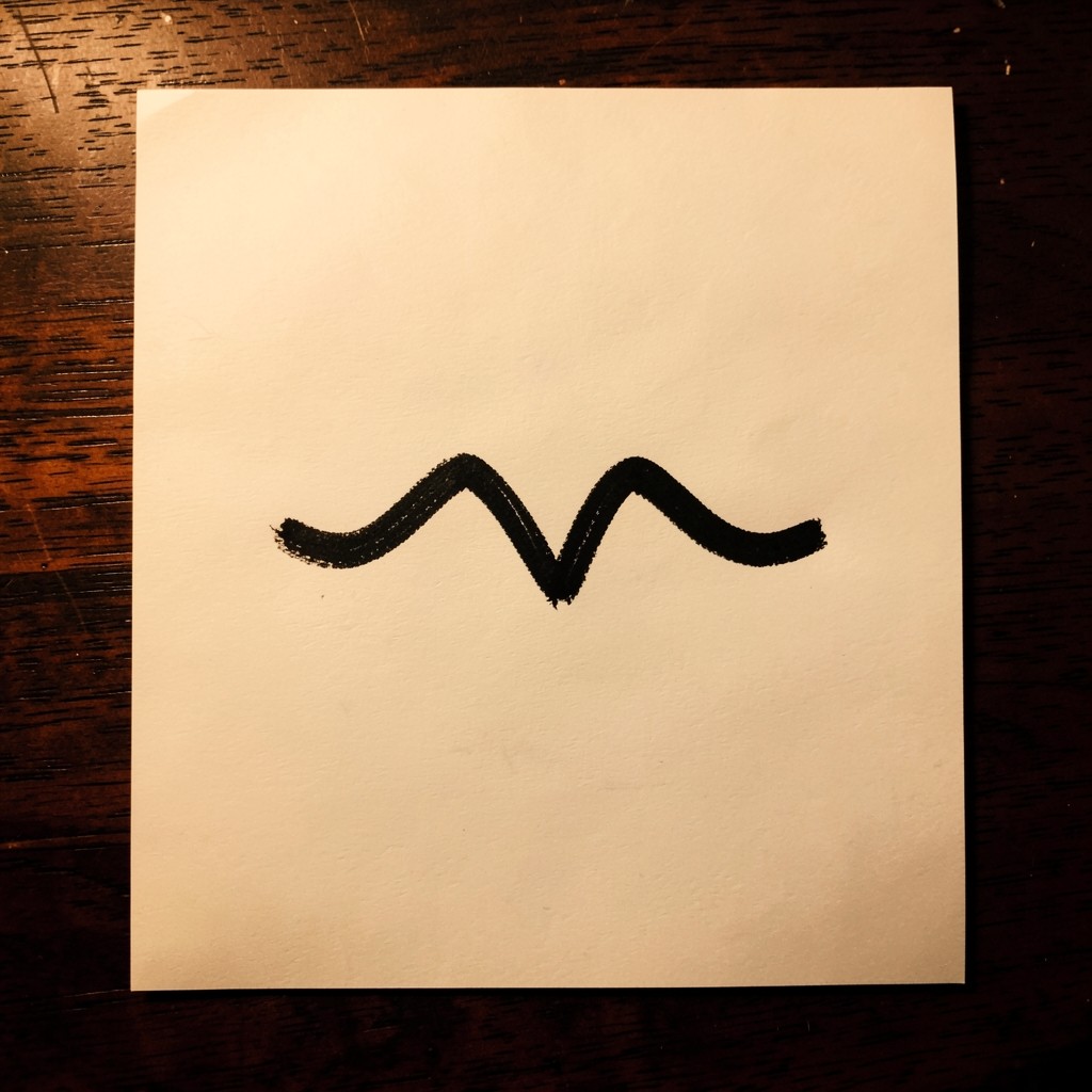 A black line on cream paper with two rounded peaks and a valley between them